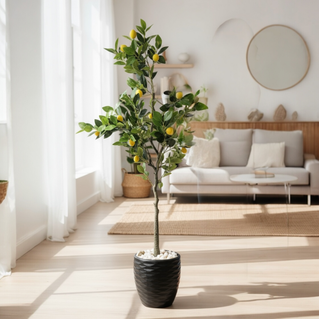 Artificial lemon tree with green leaves and yellow lemons in a black pot