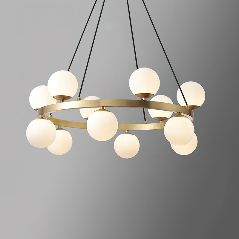 Modern brass orb chandelier with multiple round opal glass globes on a circular frame