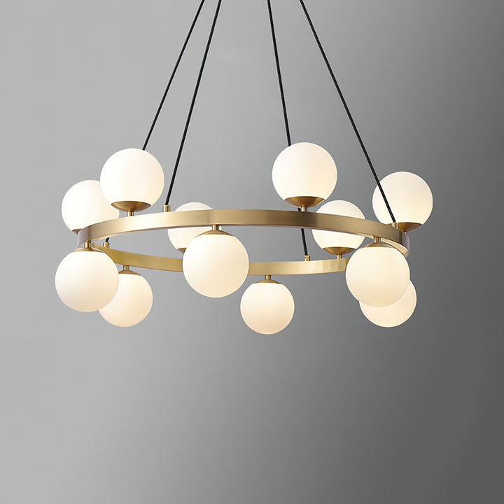Modern brass orb chandelier with multiple round opal glass globes on a circular frame