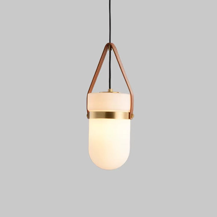 Modern pendant light with rounded opal glass shade, brown leather suspension straps, and brass accent band