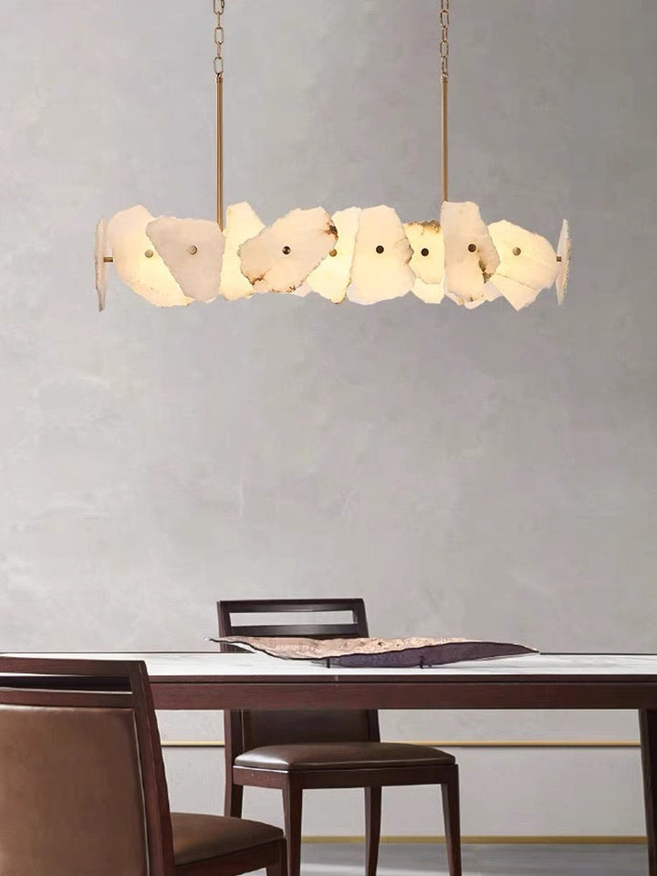 Sculptural cream petal pendant light suspended above a modern dining table