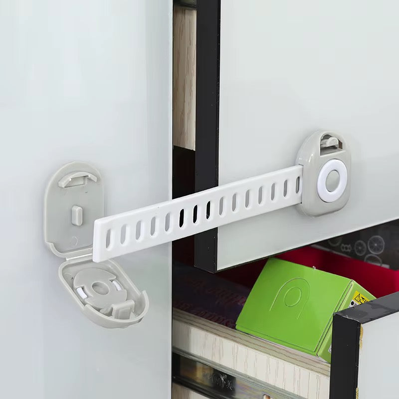 White adjustable strap lock securing a cabinet door beside a glass-front cabinet