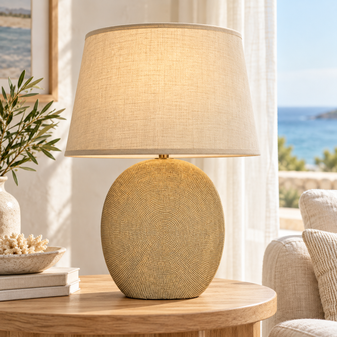 Beige table lamp with a rounded textured base and tapered fabric-look shade