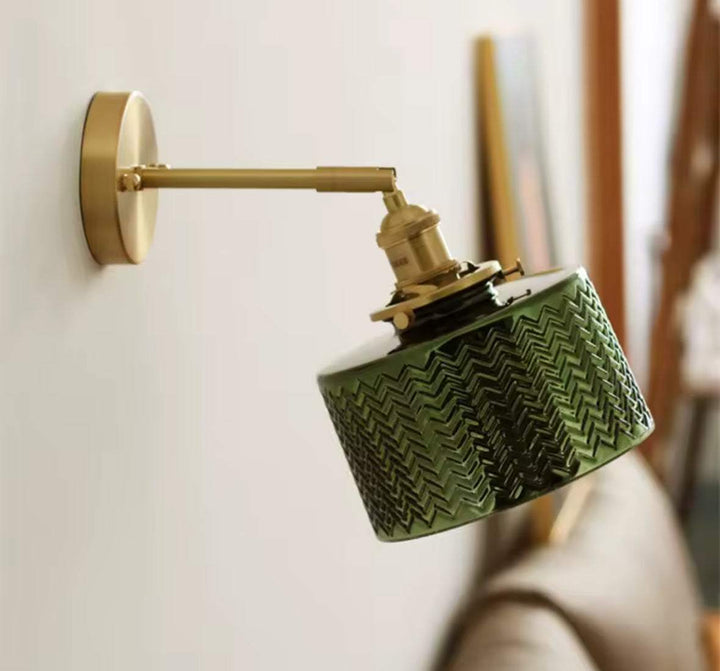 Adjustable green glass wall lamp with brass arm and textured shade