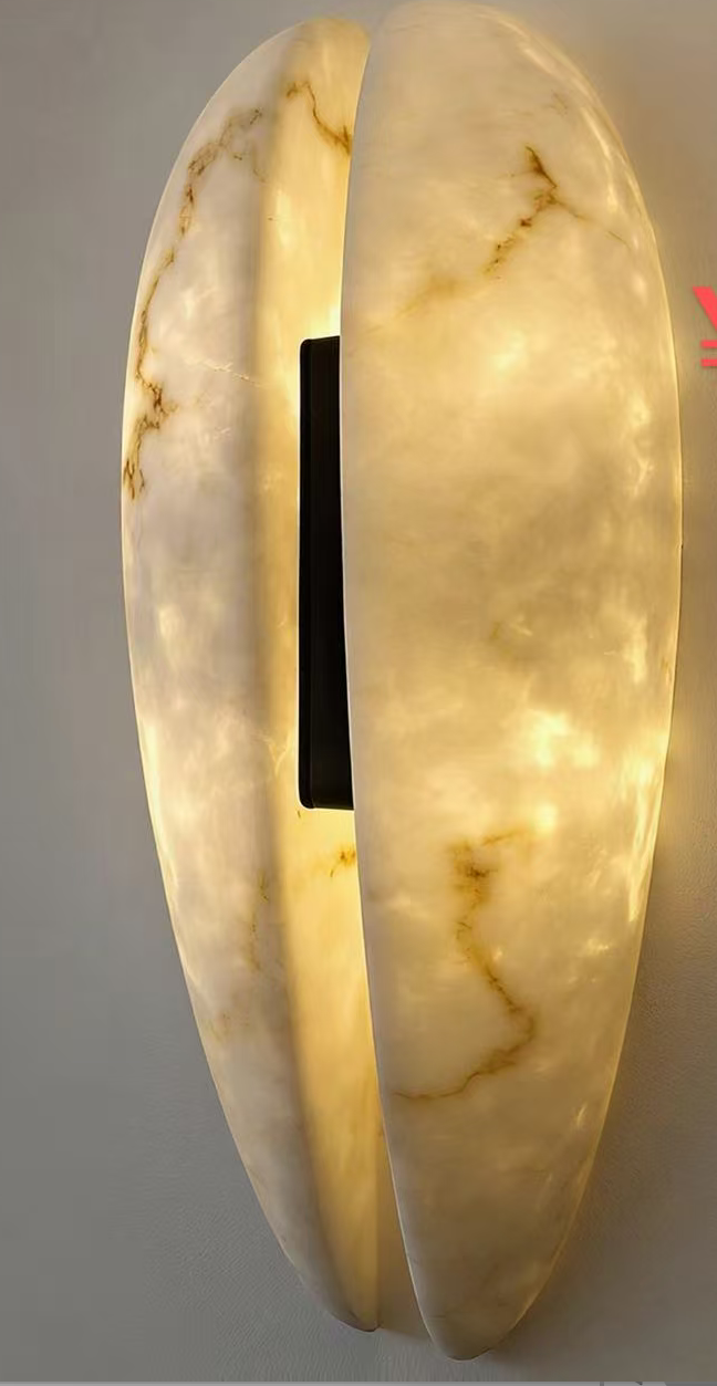 Sculptural wall light with two glowing ivory stone panels and subtle veining