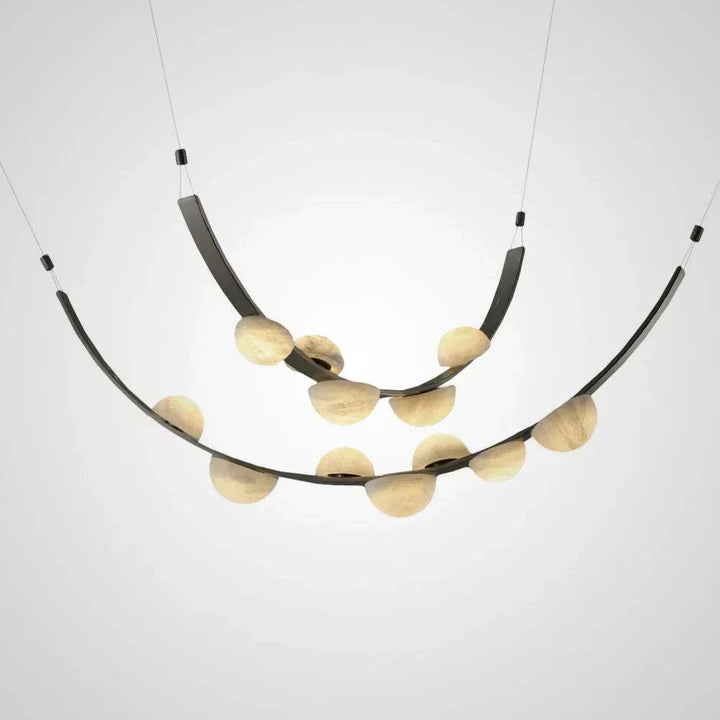 Curved alabaster stone orb chandelier with arcing metal arms and glowing globes