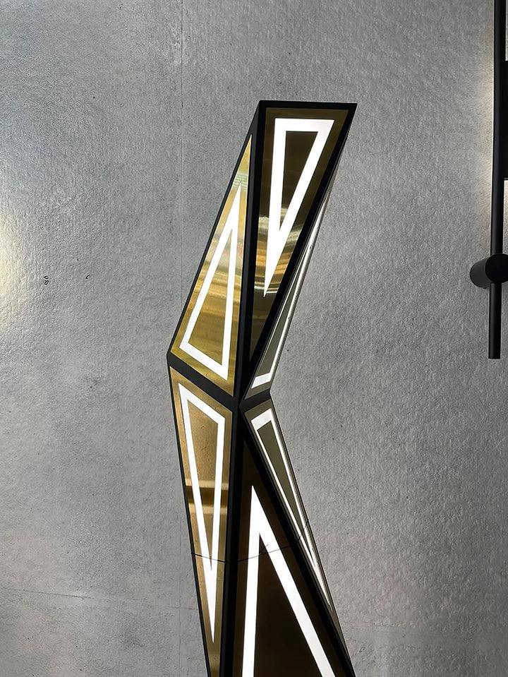 Modern wall sconce with geometric design on a gray wall