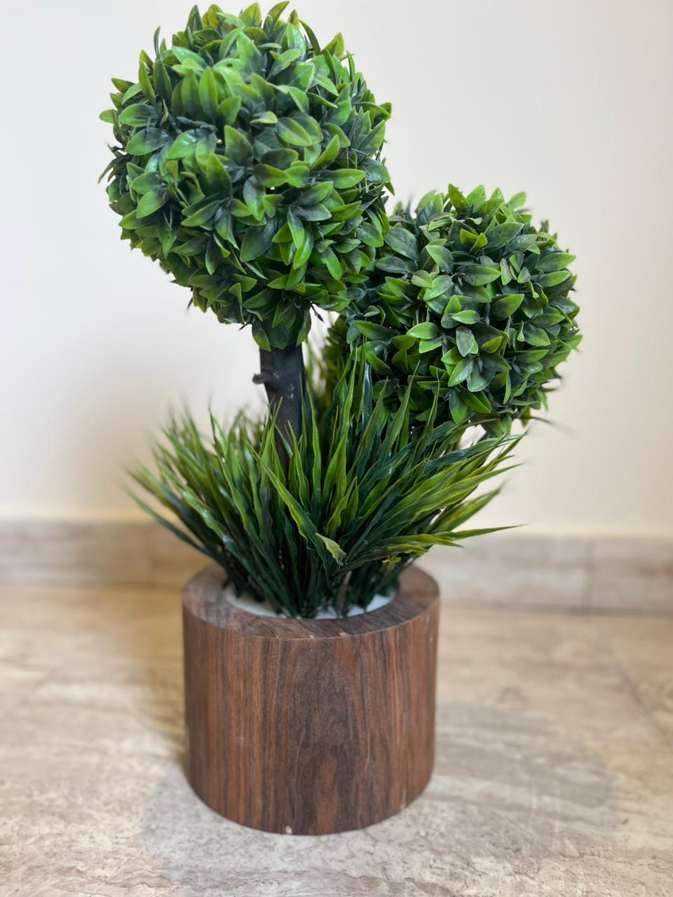 Artificial topiary plant with green foliage in a wooden-style pot