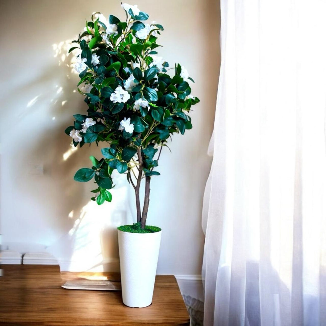 Tall artificial camellia tree with white flowers in a white textured pot