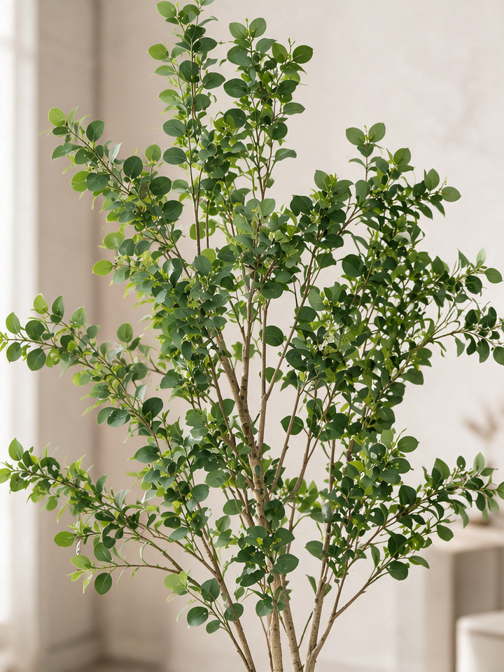 Close-up of rounded green artificial leaves and fine branches
