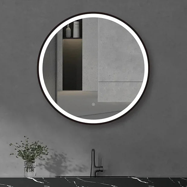 Round LED mirror with touch sensor mounted on a dark wall above a black sink
