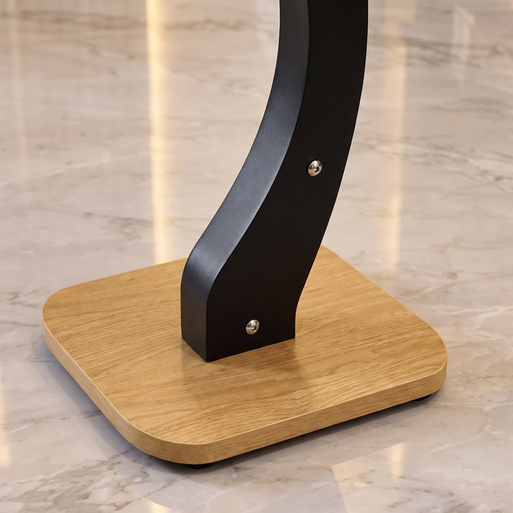 Close-up of the curved black support, silver fasteners and wood-look base