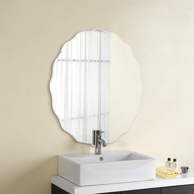 Frameless wavy edge mirror above white vanity sink