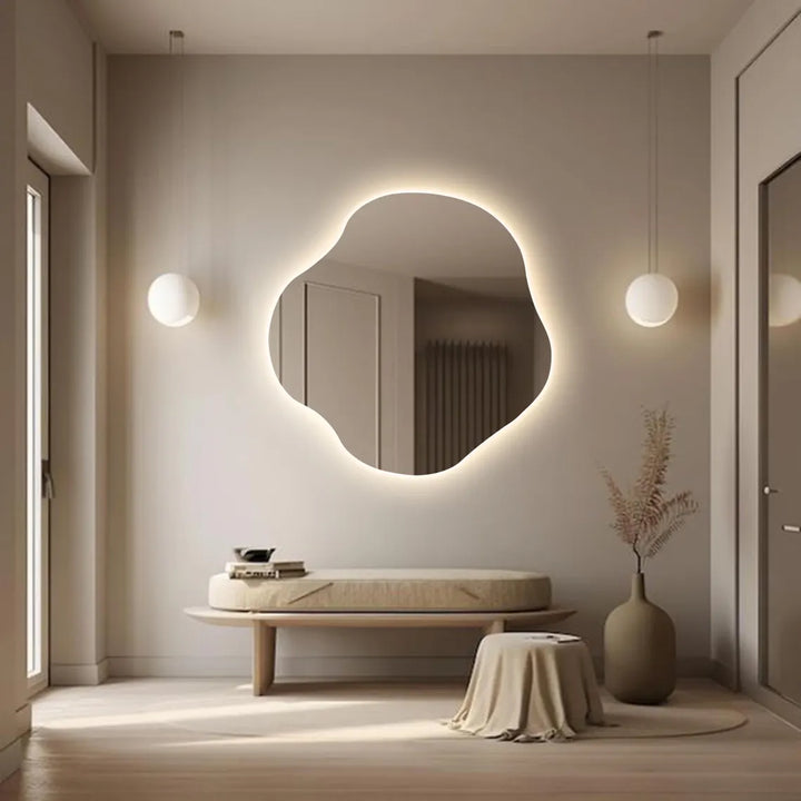 Organic-shaped wall mirror with soft LED lighting in a minimalist interior