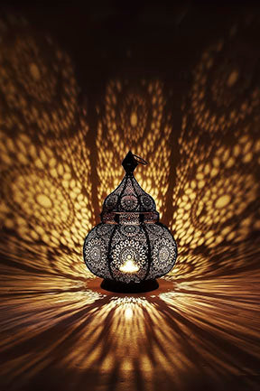 Glowing Moroccan lantern light casting intricate patterns on canvas with MDF frame and glass front.