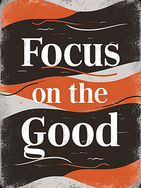 Wadi Home motivational wall art with bold white typography reading "Focus on the Good" against a distressed black, orange, and grey background.