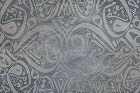 Wadi Home abstract Arabic calligraphy art in grey tones, framed and displayed above a sofa.