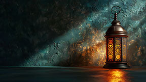Wadi Home vintage lantern illuminated wall art with intricate details and warm glow, casting dramatic light and shadow.