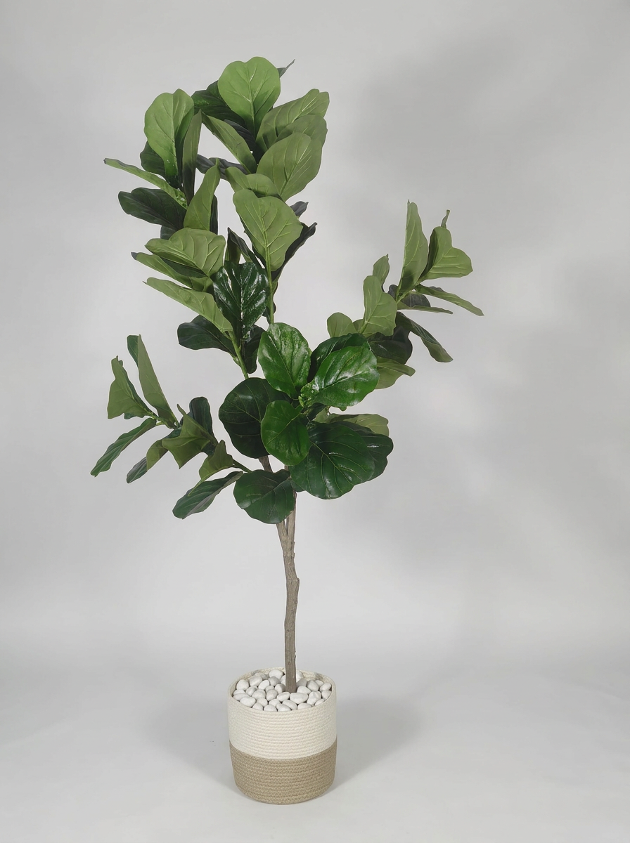 Artificial decorative plant with pot on gray studio background
