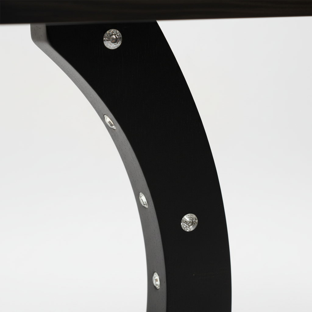 Close-up macro detail of curved table frame with professional lighting