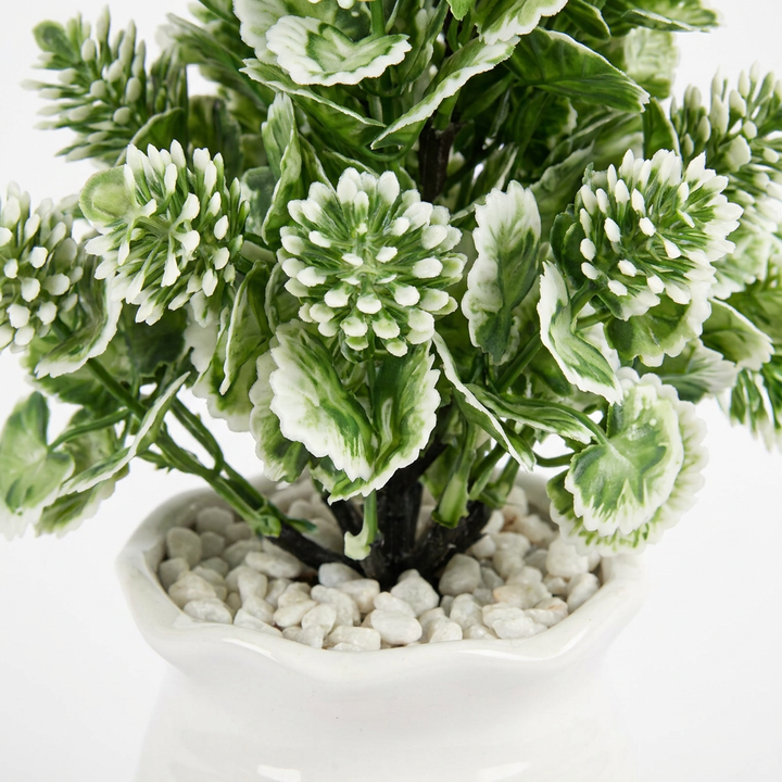 Close-up macro shot of artificial plant leaves on white background