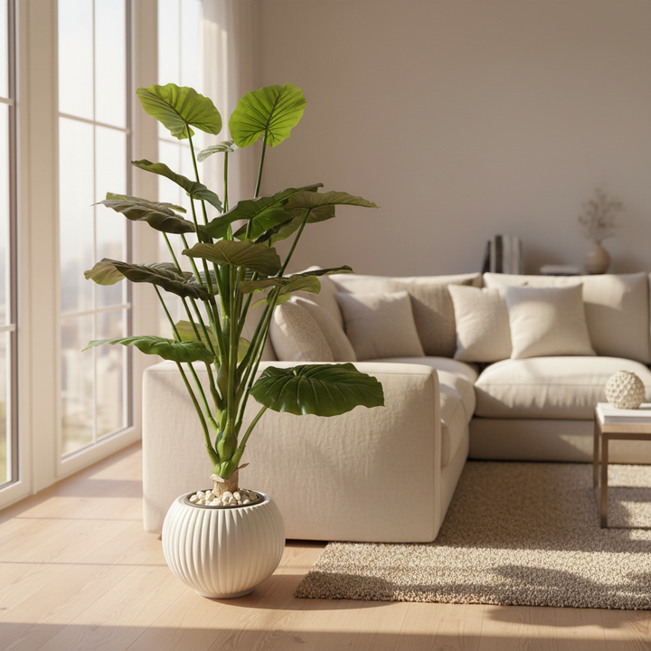 Artificial decorative plant in modern living room with cream sofa and white pebbles