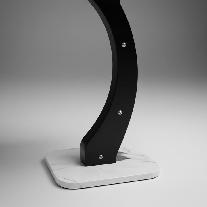 Close-up macro detail of black curved leg with precision professional lighting