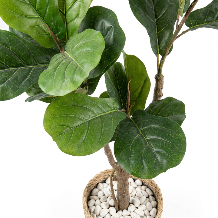 Close-up macro shot of artificial plant leaves with white pebbles