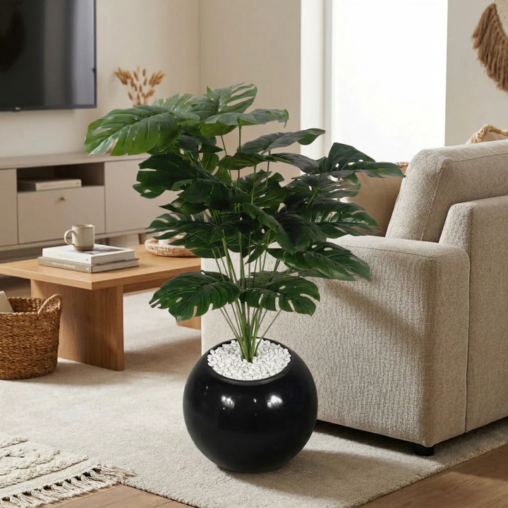 Artificial decorative plant in modern living room setting with white pebbles