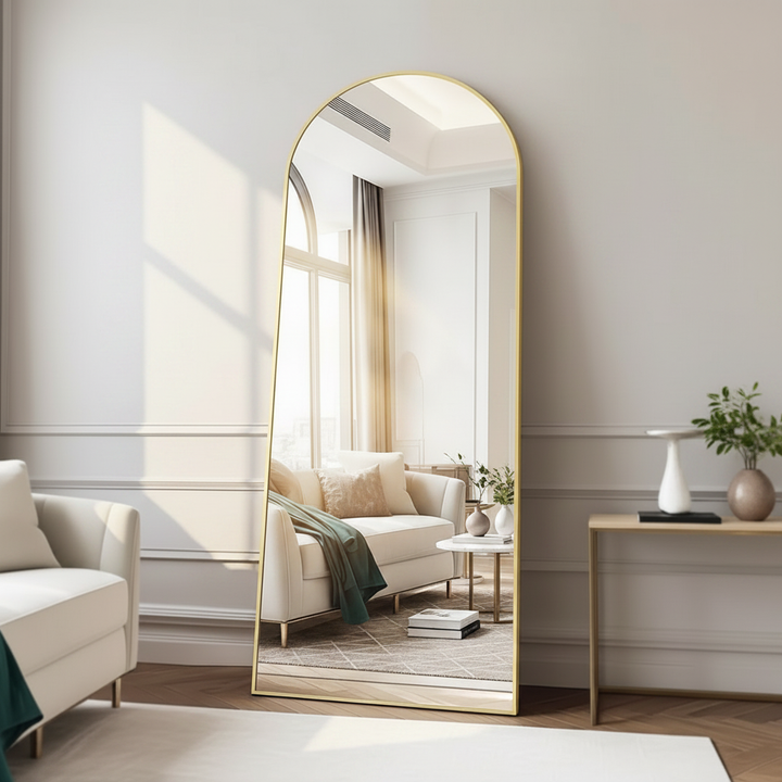 Decorative mirror with gold wooden frame leaning in modern living room
