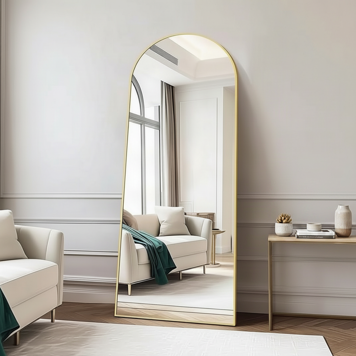 Decorative mirror standing in modern entryway against wall