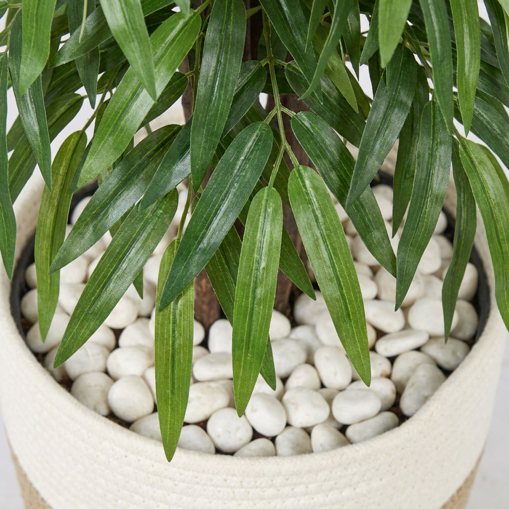 Close-up detail of artificial willow tree leaves with white pebbles