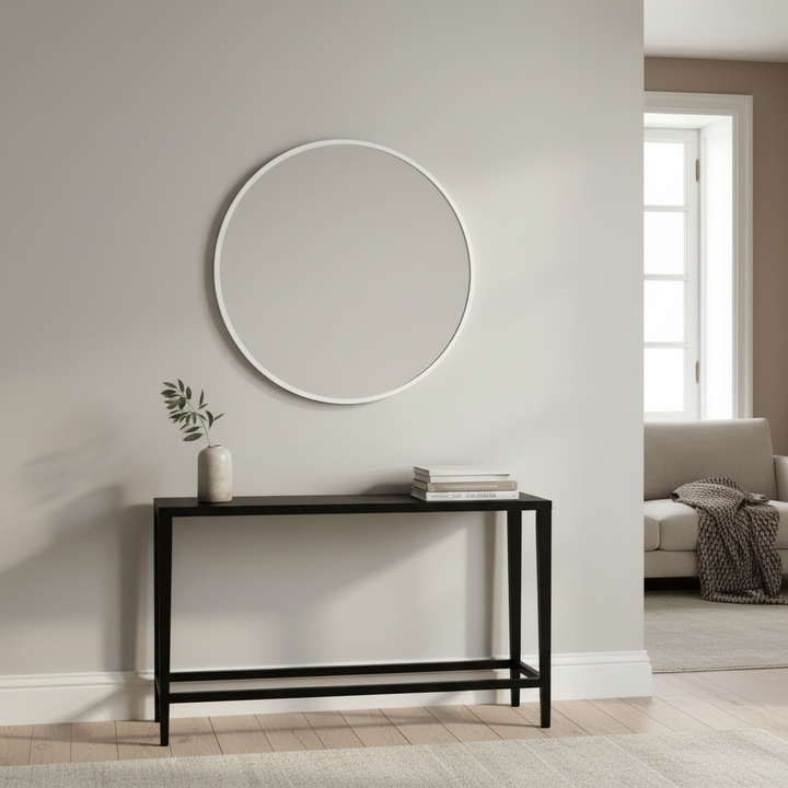 White wood-framed wall mirror in a living room above a console table
