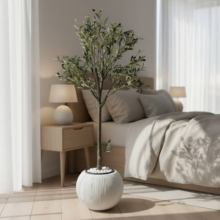 Artificial olive tree in serene bedroom corner with linen bedding