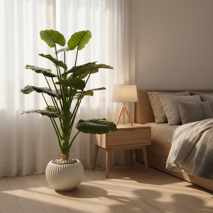 Artificial decorative plant in serene bedroom corner with linen bedding
