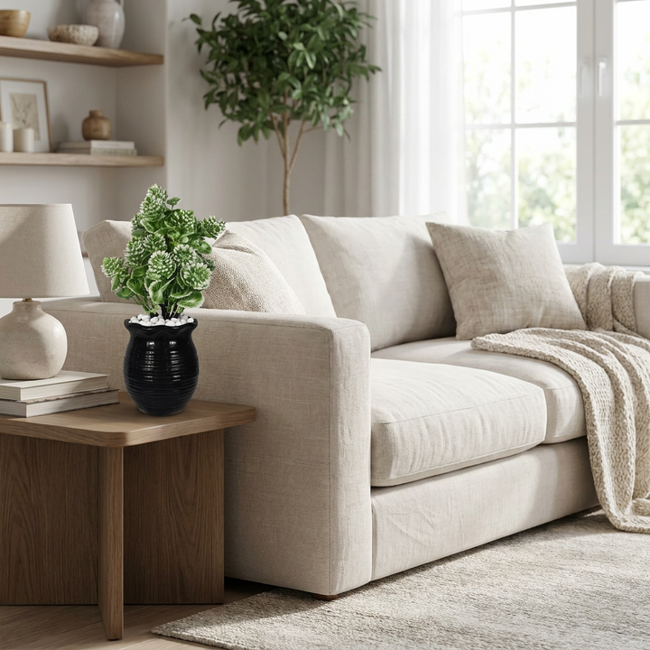Artificial decorative plant in modern living room with white pebbles