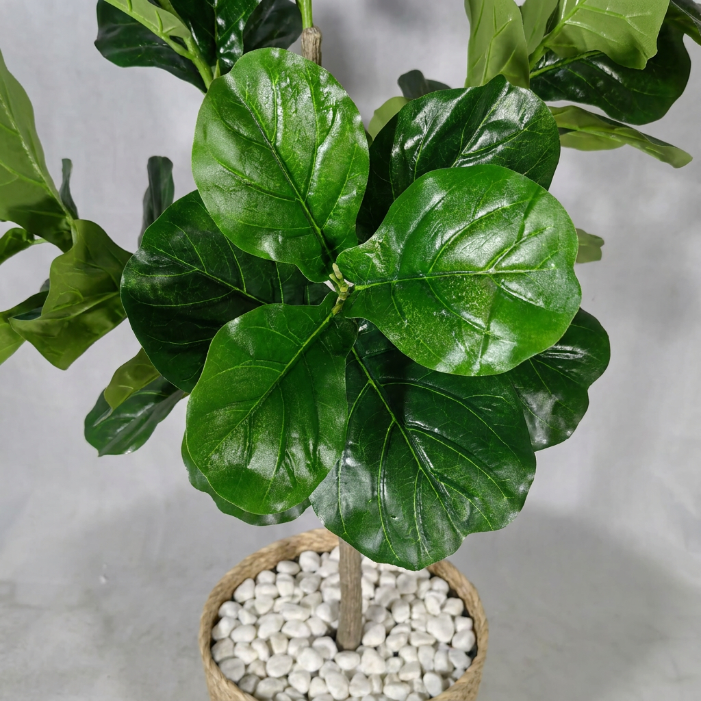 Close-up detail of artificial plant leaves with white pebbles