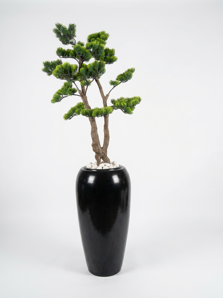 Artificial decorative plant in designer pot on white studio background