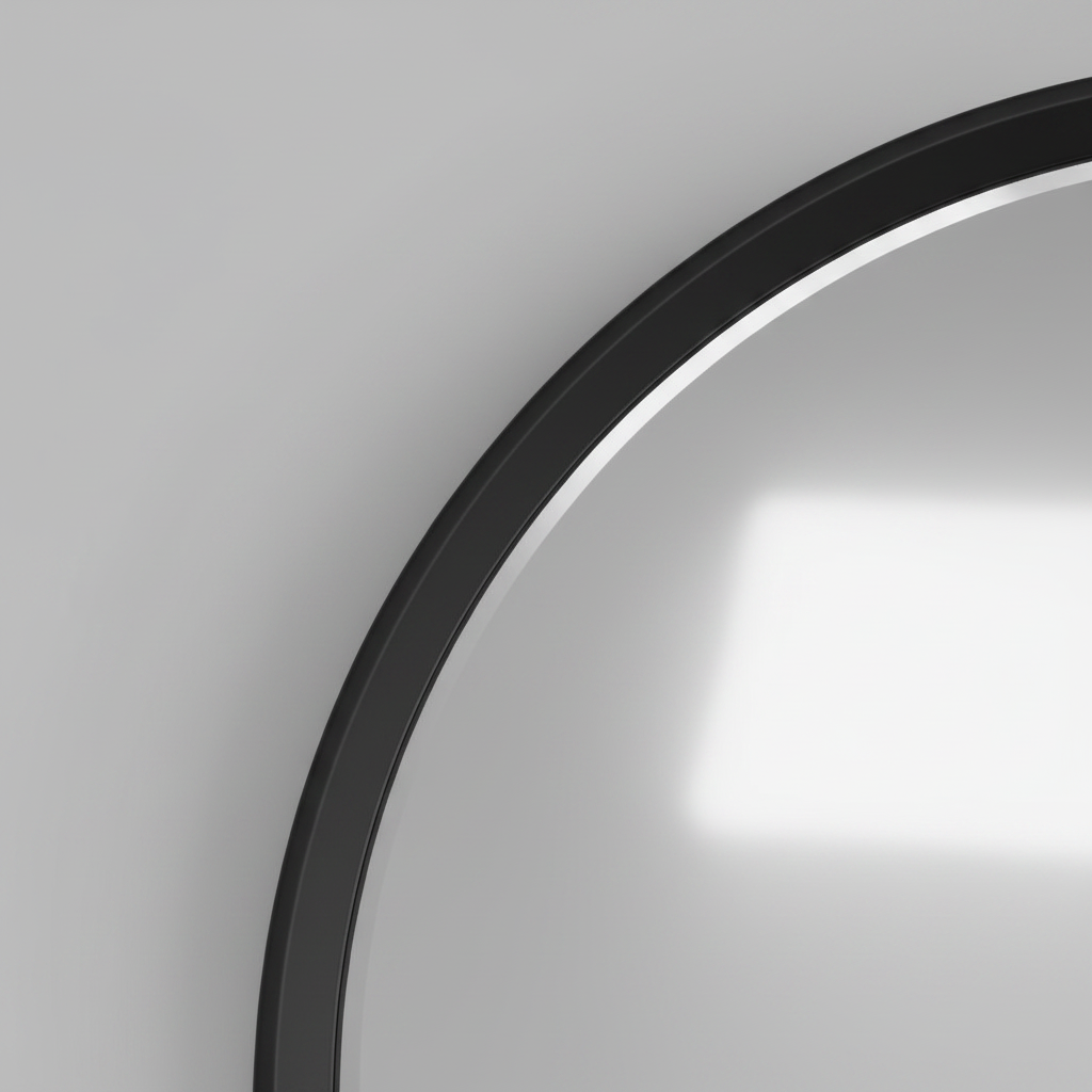 Close-up of the black frame edge meeting the mirror glass