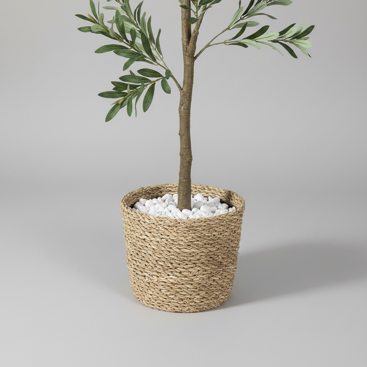 Close-up of artificial plant pot and trunk base on gray studio background