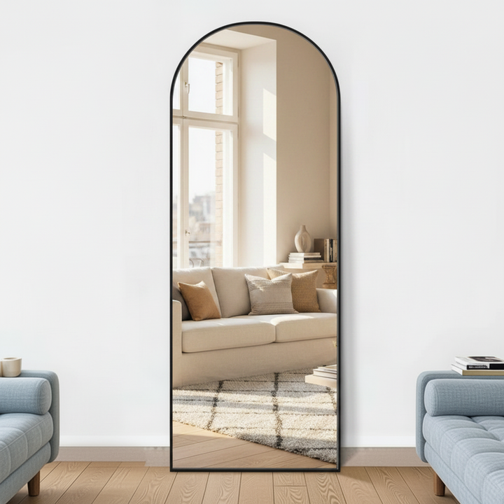 Decorative mirror with black wooden frame leaning in modern living room