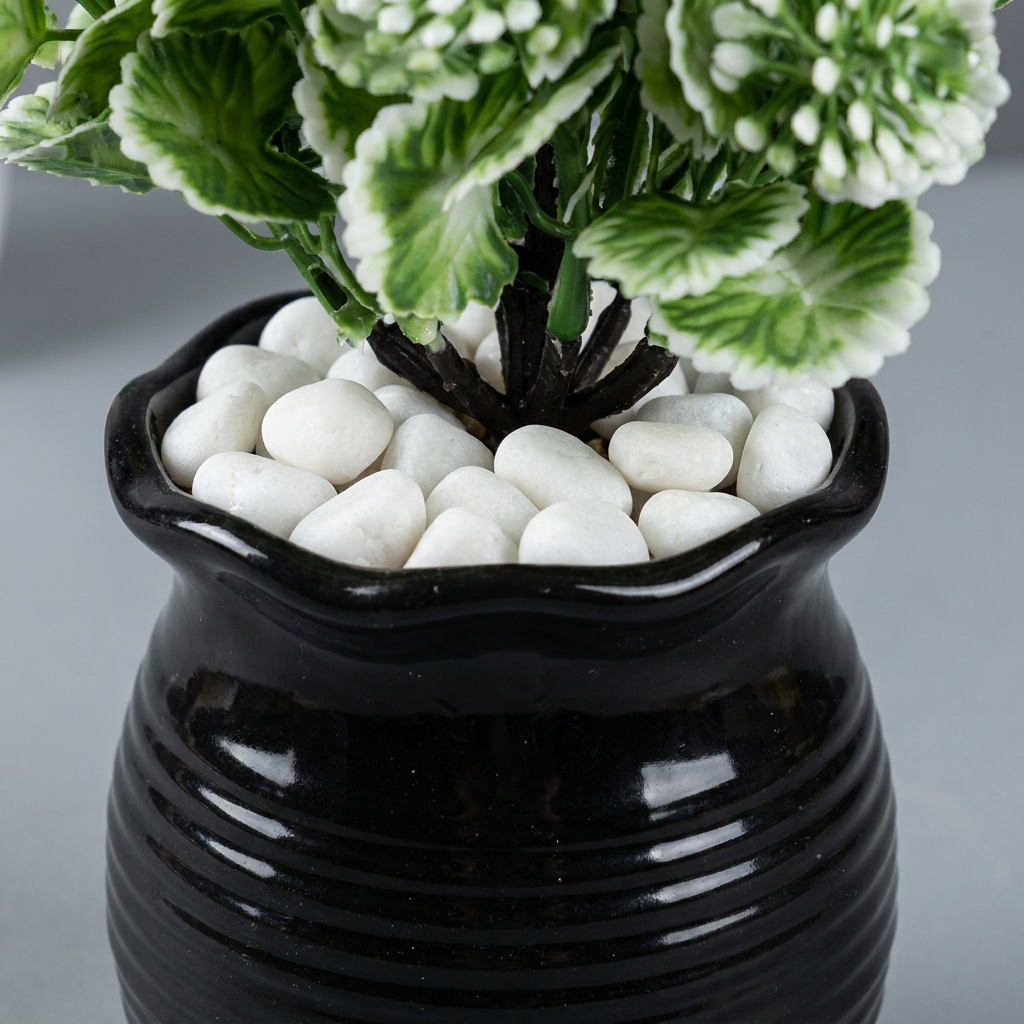 Close-up of artificial plant pot and trunk base on gray background