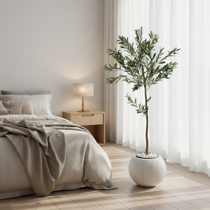 Artificial ficus tree in serene bedroom corner with linen bedding