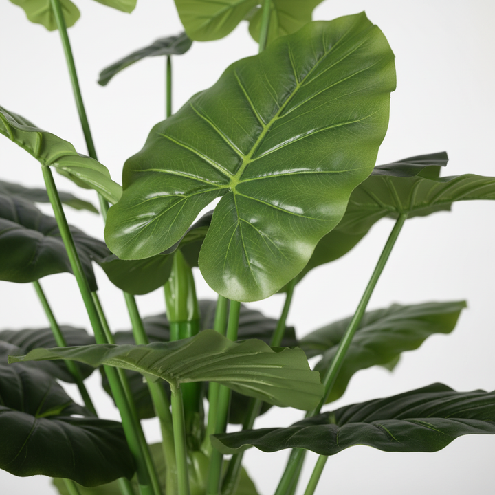 Close-up of artificial plant leaves on white studio background