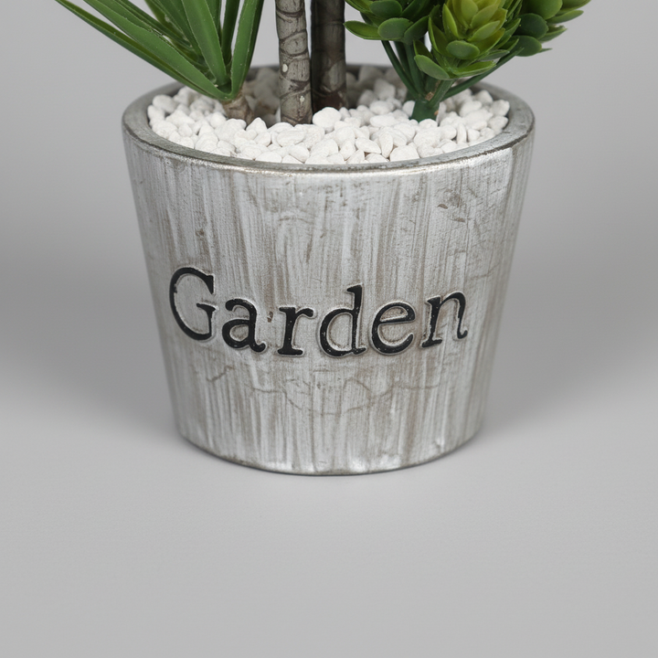 Close-up macro of artificial trailing ivy white pot on light gray studio background
