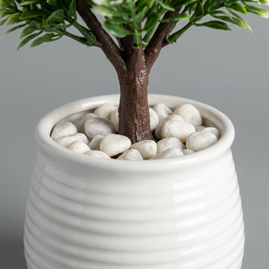 Close-up of artificial plant pot and trunk base on gray background