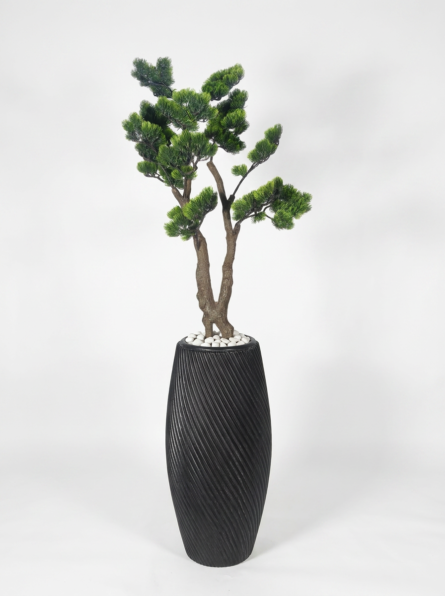Artificial decorative plant with pot on white studio background