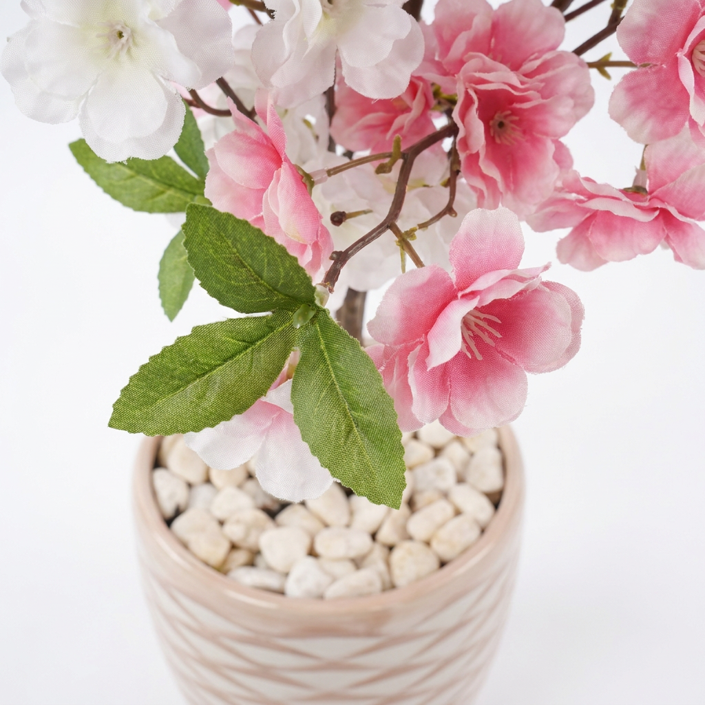 Close-up macro shot of artificial plant leaves with white pebbles