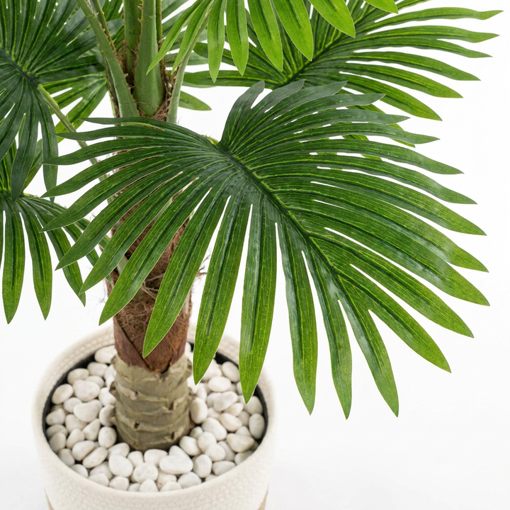Close-up detail of artificial plant leaves on white background