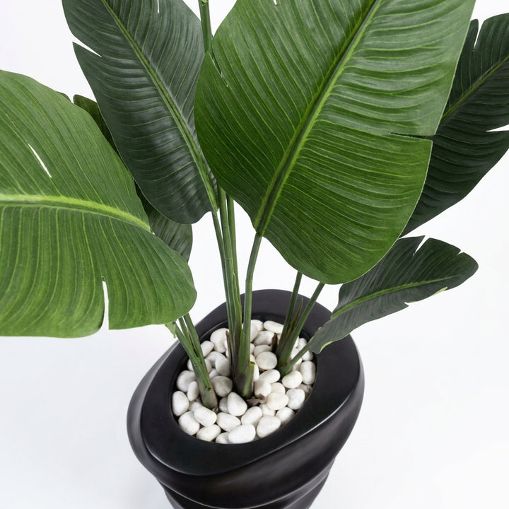 Close-up macro shot of artificial plant leaves with white pebbles